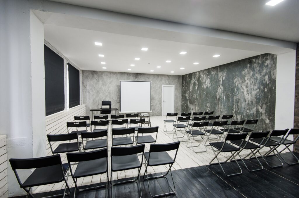Modern university group study room with white desk and chairs